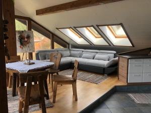 a living room with a couch and a table at Appartement Blickfang in Bruck an der Mur