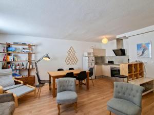 a kitchen and living room with a table and chairs at Appartement 3 pièces à Flaine, 6 pers, moderne et confortable - FR-1-425-3 in Flaine