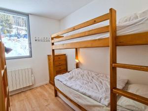 a bedroom with two bunk beds and a window at Appartement 3 pièces à Flaine, 6 pers, moderne et confortable - FR-1-425-3 in Flaine