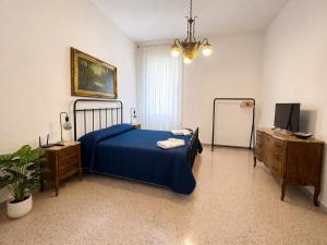 a bedroom with a bed and a dresser and a television at ADAapartmenthousesalerno in Salerno