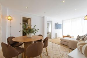 a living room with a table and chairs at L’Ancora Suite in Jávea