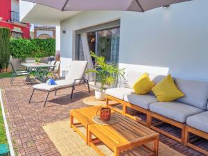 a patio with couches and a table and chairs at Villa Serena in Mijas Costa