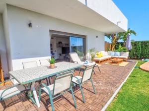 a patio with a table and chairs on a brick patio at Villa Serena in Mijas Costa +30 photos