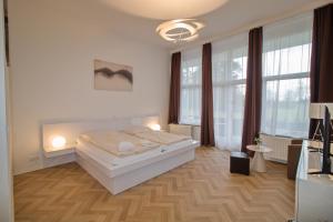a bedroom with a bed in a room with windows at Wellness Hotel Orlík in KozÃ¡rovice +91 photos