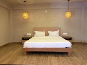 a bedroom with a large bed with two night stands at Neora Farms in Simrol
