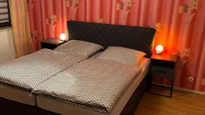 a bedroom with a bed with two lamps on tables at Ferienwohnung Irma in Malschwitz