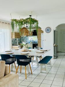 a kitchen with a table and chairs in a room at Le Cottage de L&M in Sigean