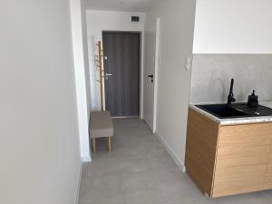 a kitchen with a sink and a counter top at CentralPark Katowice in Katowice