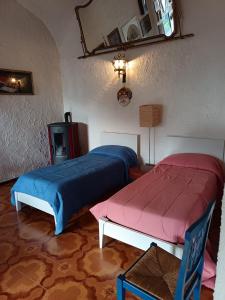 a bedroom with two beds and a table and a chair at Casa Sole Luna in Torre del Greco