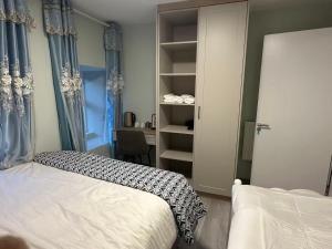 a bedroom with a bed and a closet and a desk at Cove Guest Accommodation in Kinvara
