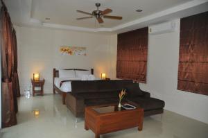 a living room with a bed and a couch at Exotic Fishing Thailand in Phangnga