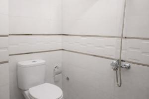 a white bathroom with a toilet and a shower at Tangier city center 3 in Tangier