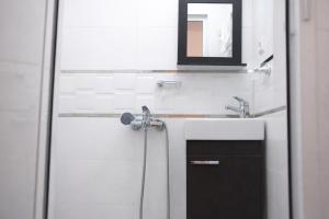 a bathroom with a shower with a mirror and a sink at Tangier city center 3 in Tangier