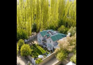 an aerial view of a house with a green roof at Rus Olive Lodge Skardu in Skardu