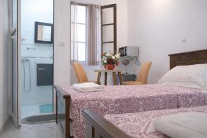 a bedroom with a bed and a table with chairs at Tangier city center 3 in Tangier
