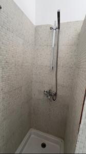 a shower in a tiled bathroom with a tub at CNS Guest House in Grand-Bassam +16 photos
