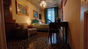 a person sitting at a desk in a room with a bedroom at DIMORA della TORRE a due passi dal mare in Sestri Levante +18 photos
