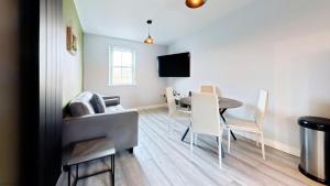 a living room with a table and a dining room at Simply The Bay - Part of the The Bay Filey Holiday Village with pool, gym and direct beach access, pub, restaurant, tennis and meadows walks in Filey