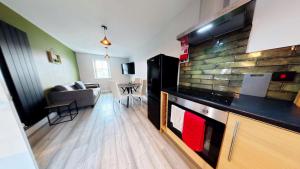 a room with a kitchen and a living room at Simply The Bay - Part of the The Bay Filey Holiday Village with pool, gym and direct beach access, pub, restaurant, tennis and meadows walks in Filey