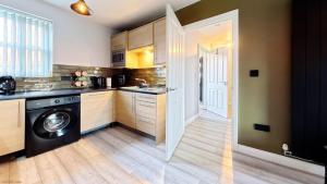 a kitchen with a washer and dryer in a room at Simply The Bay - Part of the The Bay Filey Holiday Village with pool, gym and direct beach access, pub, restaurant, tennis and meadows walks in Filey +35 photos
