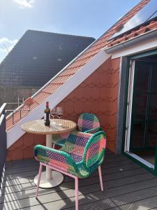 a table and two chairs on a deck at Hafen33 in Leer