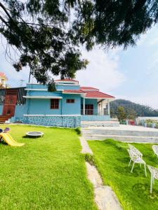 a blue house with a playground in front of it at Kalon Elpis Villa in Ooty