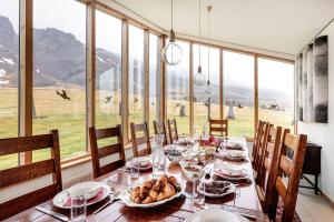 a dining room with a table with food on it at Silfurberg in Þorgrímsstaðir
