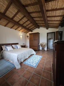 a bedroom with a bed and a tiled floor at Stazzu Barecca B&B in Cugnana Verde