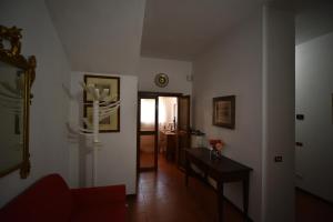 a living room with a red couch and a table at Via Belvedere 50 in Montefalco