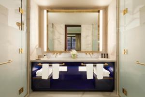 a bathroom with a sink and a mirror at Hard Rock Hotel New York - Partner of ALL Accor in New York +90 photos