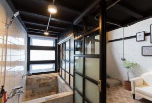 a room with a glass door leading to a bathroom at You Worth Inn in Hualien City
