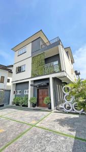 a large white building with a red door at 3Apartments in Lagos