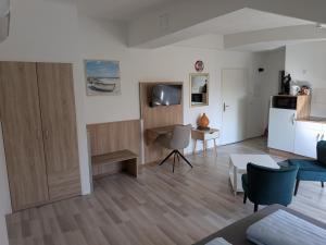 a living room with a table and a kitchen at Air 41 in Konstanz