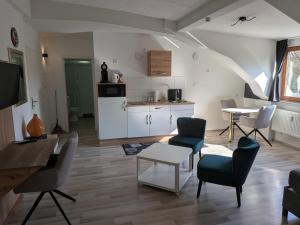 a living room with a table and chairs and a kitchen at Air 41 in Konstanz +18 photos