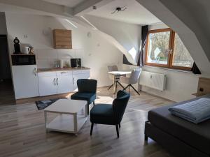 a living room with a couch and a table and a kitchen at Air 41 in Konstanz