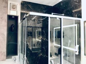 a bathroom with a shower with a glass door at Lumbini in Varanasi