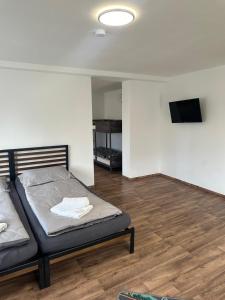 a bedroom with a bed and a flat screen tv at R&B pension in Ichenhausen