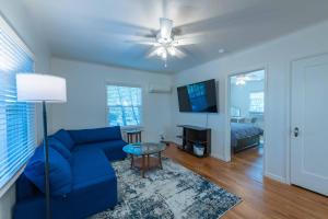 a living room with a blue couch and a tv at Park Street Pad in Paso Robles