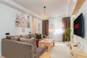 a living room with a couch and a table at Taghazout Bay Chic Residence Sea View in Tamraght Ouzdar