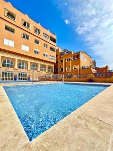a swimming pool in front of a building at Taghazout Bay Chic Residence Sea View in Tamraght Ouzdar