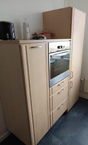 a kitchen with a refrigerator and a stove at Ferienwohnung Lea in Sangerhausen +9 photos