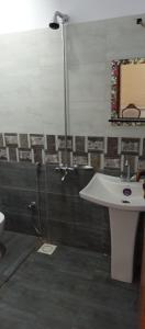 a bathroom with a shower and a sink and a sink at Nursery Suites in Karachi