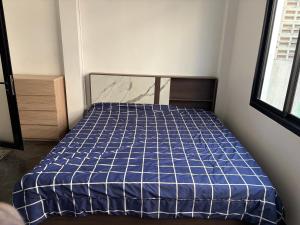 a bedroom with a bed with a blue comforter at SET Guesthouse 3 in Kata Beach +9 photos