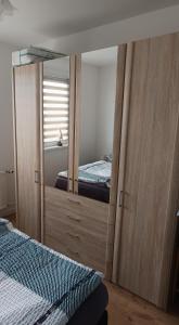 a bedroom with a mirror with a bed in it at Ferienwohnung Lea in Sangerhausen