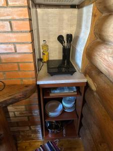a small table with plates and a blender on it at Mõnus palkmaja Muhu mändide all in Nõmmküla