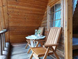 a table and chairs on the porch of a cabin at Mõnus palkmaja Muhu mändide all in Nõmmküla