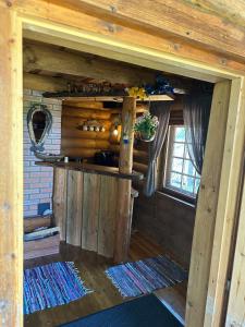 an inside view of a room in a log cabin at Mõnus palkmaja Muhu mändide all in Nõmmküla +24 photos