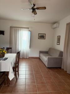 a living room with a couch and a table at La Dimora del Molo in Fuscaldo