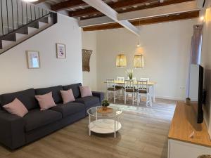 a living room with a couch and a table at Casa Centenaria 1769 in Cubelles