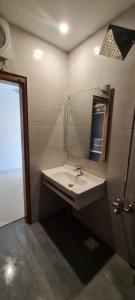 a bathroom with a sink and a mirror at Abbott royale farm in Abbottabad